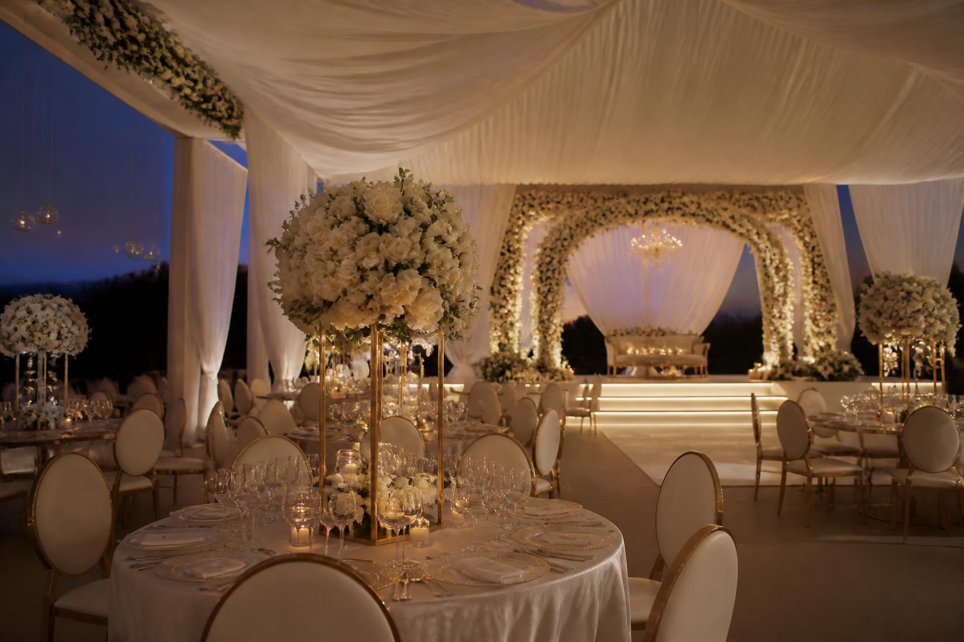 Candlelit wedding reception with floral arch and draped ceiling styled by Jeminii Event Styling